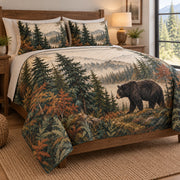 Black Bear Forest Nature Quilt Set on a bed, angled view showing the quilt design and two coordinating pillow shams