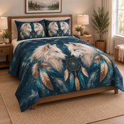 White Wolf Dreamcatcher Feather Quilt Set on a bed, angled view showing the quilt design and two coordinating pillow shams