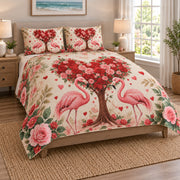 Couple Flamingo Rose Heart Quilt Set on a bed, angled view showing the quilt design and two coordinating pillow shams
