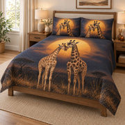 Romantic Giraffe Couple Sunset Quilt Set on a bed, angled view showing the quilt design and two coordinating pillow shams