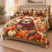 Autumn Sloth Pumpkin Harvest Quilt Set on a bed, angled view showing the quilt design and two coordinating pillow shams