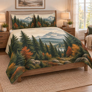 Mountain Forest Autumn Landscape Quilt Set on a bed, angled view showing the quilt design and two coordinating pillow shams