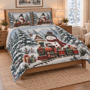 Christmas Snowman Train Winter Quilt Set on a bed, angled view showing the quilt design and two coordinating pillow shams