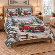Christmas Red Truck Snowy Forest Quilt Set on a bed, angled view showing the quilt design and two coordinating pillow shams