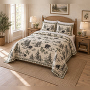 Black bear country toile quilt set from an angled view, showing the quilt and two matching shams