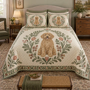 A curly goldendoodle sits inside a sage botanical wreath with small flowers and a narrow decorative border on cream on a quilt set with two matching shams, front view.