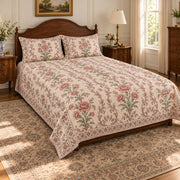 AI-generated mockup, pulled-back front-left view of Carnation floral quilt set with printed border and diamond quilting.