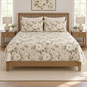 Ivory rose quilt set on a long oak bed, front hero view