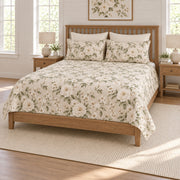 Ivory rose quilt set on a long oak bed, right angle view