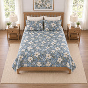 Dusty denim dogwood quilt set, elevated straight-on overhead view