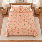 Soft peach hummingbird and fuchsia quilt set overhead view