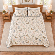 Warm ivory swallowtail butterfly and wildflower meadow quilt set overhead view