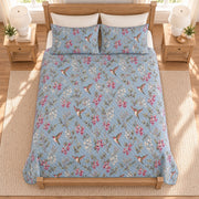 Dusty blue hummingbird and fuchsia quilt set overhead view