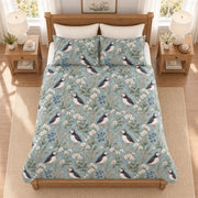 Muted coastal teal Atlantic puffin and sea campion quilt set elevated overhead view