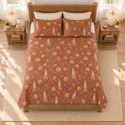 Warm terracotta meerkat and desert marigold quilt set, elevated overhead view