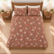 Dusty rose hedgehog and apple blossom quilt set, elevated overhead view