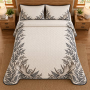 AI mockup, high overhead bedroom view of a moose quilt with palmate moose antlers and botanical border and two matching printed pillow covers.