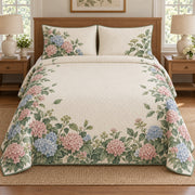 AI mockup, front bedroom view of a hydrangea quilt with pink and blue hydrangea hedge border and two matching printed pillow covers.