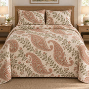 AI mockup, front bedroom view of a paisley quilt with terracotta paisley teardrops and sage garden leaves and two matching printed pillow shams.