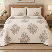 AI mockup, front bedroom view of a paisley quilt with floating paisley islands on cream and two matching printed pillow shams.