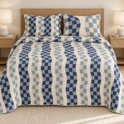 AI mockup, front bedroom view of a gingham quilt with wavy gingham check columns and two matching printed pillow shams.