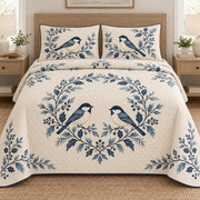 AI mockup, front bedroom view of a Christmas quilt with blue folk birds and leafy garlands and two matching printed pillow shams.