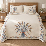 AI mockup, front bedroom view of a farmhouse quilt with wheat sheaf medallion and blue botanical border and two matching printed pillow shams.
