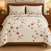 AI mockup, front bedroom view of a mid century modern quilt with terracotta and olive dots linked by fine lines across cream and two matching printed pillow covers.