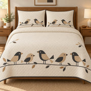 AI mockup, front bedroom view of a mid century modern quilt with five tan and charcoal geometric birds perched along a leafy branch on cream and two matching printed pillow covers.