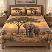 African Elephant Savanna Sunset quilt set displayed on a bed with coordinating pillow shams
