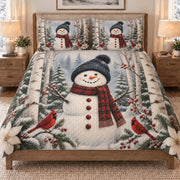 Christmas Snowman Cardinal Forest quilt set displayed on a bed with coordinating pillow shams