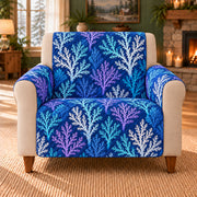 Deep Coral Branch Repeat sofa cover on a beige armchair