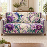 two hummingbirds in a purple flower garden quilted sofa cover shown on a sofa, AI mockup