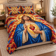 Angled view of stained glass Sacred Heart quilt set with matching cross shams