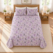 Muted lavender cat and wisteria quilt set, elevated overhead view