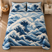 AI mockup, high centered overhead view of layered deep blue ocean waves with curling white foam, quilt and two matching printed pillowcases in a neutral bedroom.