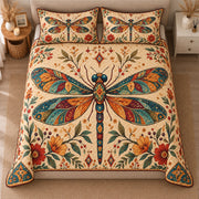 AI mockup, high centered overhead view of an ornate jewel toned dragonfly with patterned wings amid folk flowers on cream, quilt and two matching printed pillowcases in a neutral bedroom.