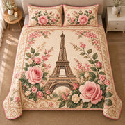 AI mockup, high centered overhead view of the Eiffel Tower framed by blush pink roses on a vintage cream background, quilt and two matching printed pillowcases in a neutral bedroom.