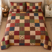 AI mockup, high centered overhead view of a grid of rustic earth toned plaid floral and textured squares in red gold green navy and cream, quilt and two matching printed pillowcases in a neutral bedroom.