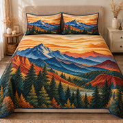 AI mockup, front view of layered blue mountains and pine forest beneath a glowing amber sunset sky, quilt and two matching printed pillowcases in a neutral bedroom.
