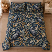 AI mockup, high centered overhead view of blue gray ravens perched among winding leafy branches on dark navy, quilt and two matching printed pillowcases in a neutral bedroom.