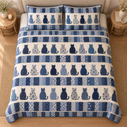 AI mockup, high centered overhead view of rows of navy and floral cat silhouettes between blue patchwork stripes, quilt and two matching printed pillowcases in a neutral bedroom.