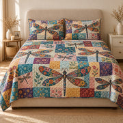 AI mockup, front view of large dragonflies with colorful patchwork wings over floral quilt squares, quilt and two matching printed pillowcases in a neutral bedroom.
