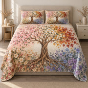 AI mockup, front view of a central twisting tree with pink blossoms, white flowers, orange leaves and lavender blooms, quilt and two matching printed pillowcases in a neutral bedroom.
