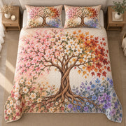 AI mockup, high centered overhead view of a central twisting tree with pink blossoms, white flowers, orange leaves and lavender blooms, quilt and two matching printed pillowcases in a neutral bedroom.
