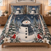 Snowman Cardinal Winter Forest quilt set displayed on a bed with coordinating pillow shams