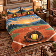 Elevated left-angle view AI mockup of the Softball Diamond Sunrise fastpitch softball quilt set with two coordinating printed pillow shams.