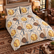 Elevated left-angle view AI mockup of the Softball Ribbon Court fastpitch softball quilt set with two coordinating printed pillow shams.