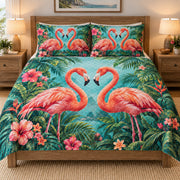 Tropical Flamingo Love Floral quilt set displayed on a bed with coordinating pillow shams