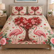 Couple Flamingo Rose Heart quilt set displayed on a bed with coordinating pillow shams
